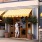 Person entering a storefront with a yellow-striped awning