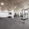 Spacious gym with weight racks, workout equipment, and mirrors