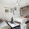 Modern studio apartment with bed, couch, and wall art