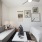 Studio apartment with a couch, coffee table, and art-covered wall