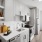 Contemporary kitchen with white cabinetry, stainless steel appliances, and balcony view